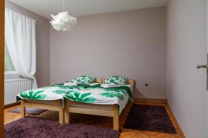 a small bed in a room with a purple rug at Apartment Mihajlovic in Vranje