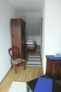 a room with a chair and a cabinet and a table at Dworska Zagroda in Korytowo +52 photos