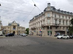 a large building on a city street with cars at Odessa 3bedroom Deribas apartment in Odesa