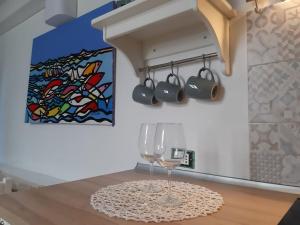 a dining room with a wine glass on a table at Finestra Azzurra in San Vito lo Capo