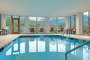 a swimming pool with a view of the mountains at The Glen House in Gorham