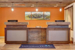 an office with an orange wall with a reception counter at The Glen House in Gorham +41 photos