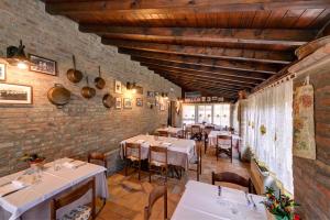a restaurant with tables and chairs in a room at Il Dosso Agriturismo in Codigoro