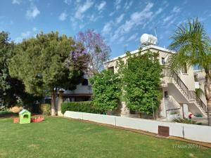 a building with a yard in front of it at Maricosta Apartments in Protaras