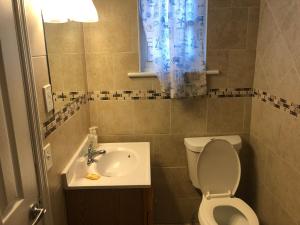 a small bathroom with a toilet and a sink at 3 Bedroom Apartment in Seaside Heights