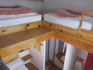 two bunk beds in a small room with a wooden floor at Onkel Inn in La Paz