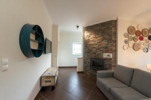 a living room with a couch and a fireplace at Casa Poesia in Castanheira de Pêra