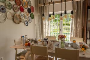 a dining room with a table and plates on the wall at Casa Poesia in Castanheira de Pêra +16 photos