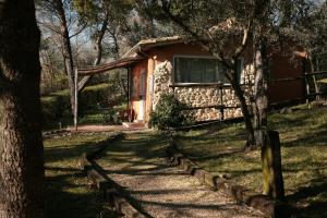 a cabin in the middle of a field with trees at Malvarina in Capodacqua