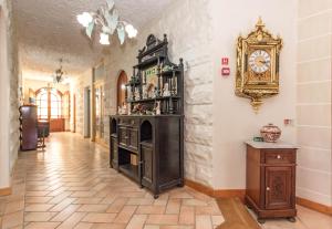 a room with a fireplace and a clock on the wall at Kikka B&B in Tarxien