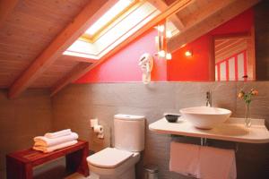 a bathroom with a white toilet and a sink at Posada Casona de la Ventilla in Laredo +37 photos