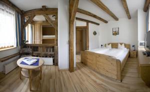 a large bedroom with a large bed and a table at Hotel Hohe Tauern in Matrei in Osttirol