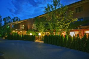 a building with a lit up facade at night at Hotel Ai Gelsi in Codroipo