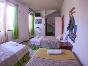 En eller flere senger på et rom på Tintorera Guest House