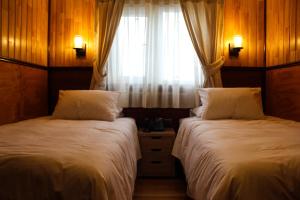 Postel nebo postele na pokoji v ubytování Hotel Aliwen