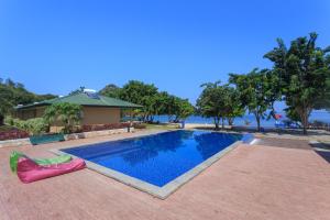 a swimming pool in front of a house at Sylvia Beach Villa in Labuan Bajo