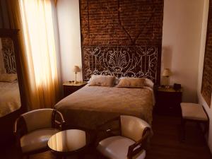 a bedroom with a bed and two chairs at Hotel A&B Internacional in Buenos Aires