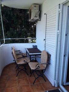 a patio with a table and chairs on a porch at Apartment Milica in Herceg-Novi