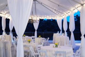 a marquee set up for a wedding with white tables and chairs at Hyatt Regency Atlanta Perimeter at Villa Christina in Atlanta +37 photos