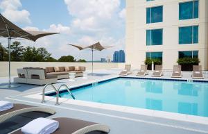 a hotel room with a swimming pool and a swimming pool chair at Hyatt Regency Atlanta Perimeter at Villa Christina in Atlanta