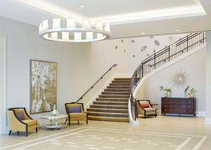 a living room filled with furniture and a stairway at Hyatt Regency Atlanta Perimeter at Villa Christina in Atlanta