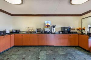 a large room with brown cabinets and a room with at Econo Lodge in Florence