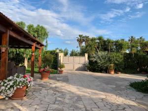 a patio with potted plants and a fence at A Casa di Diamante in Bisceglie