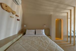 a bedroom with a bed and a mirror in it at Sublime Villa & Caves in Akrotiri