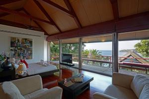a living room with a view of the ocean at Surin Beach Ocean front Villa between Kamala and BangTao Beaches in Surin Beach