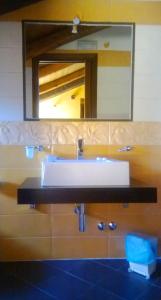 a bathroom with a sink and a mirror at Residenza Il Duomo in Tropea