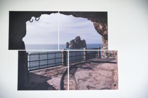 a picture of the ocean and a window with a view at Bed and Breakfast Porto Flavia in Iglesias