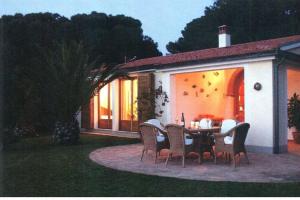 a table and chairs in front of a house at Villa Peducelli by Agenzia SolturElba in Capoliveri
