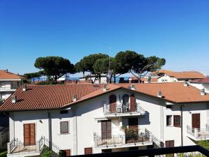 a white building with a red roof at Hotel Caprice in Marina di Massa