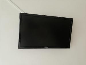 a flat screen tv hanging on a wall at Hotel Caprice in Marina di Massa