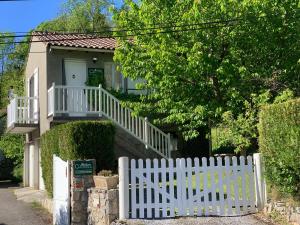 a white picket fence in front of a house at Maison Cancela in Siguer