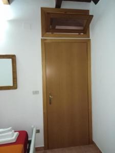 a wooden door in a room with a ceiling at Residence San Salvatore in Palinuro