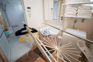 a bathroom with a rack of towels and a mirror at Pine House in ISHIGAKI in Ishigaki Island +37 photos