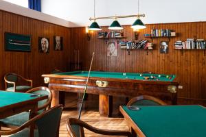 a billiard room with a pool table and some chairs at Grand Hotel Excelsior in San Benedetto del Tronto