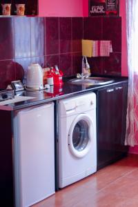 a kitchen with a washing machine and a sink at Galavani in Tbilisi City