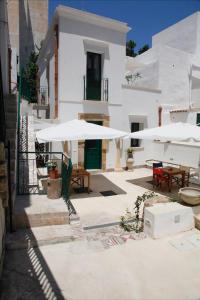 un patio con tavoli e ombrelloni su un edificio di Storie di mare a Marsala