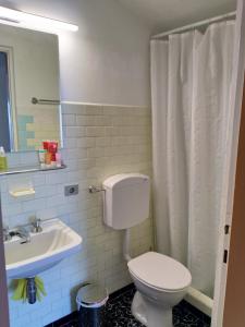 a bathroom with a toilet and a sink at Casa Lago Azzurro Apartement in Cannobio