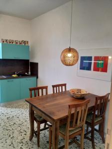 a dining room with a wooden table and chairs at Casa Lago Azzurro Apartement in Cannobio