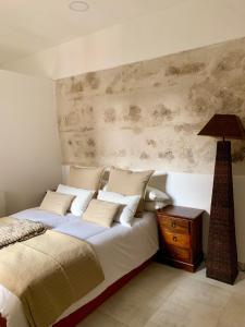 a bedroom with a bed and a lamp on a night stand at El Apartamento de la Yaya in Toledo