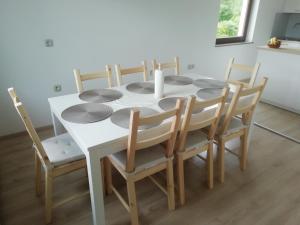 a dining room table and chairs with a white table at CARNIOLAN HOUSE - GORENSKA HIŠKA in Radovljica