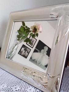 a picture frame with a vase with flowers in it at The Roses Garden in La Maddalena
