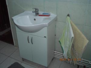 a bathroom with a white sink and a towel at Vila Mihaela in Breaza +43 photos