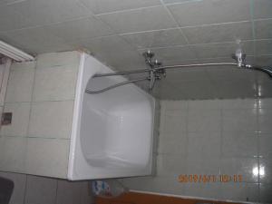 a white urinal in a bathroom with a shower at Vila Mihaela in Breaza +39 photos