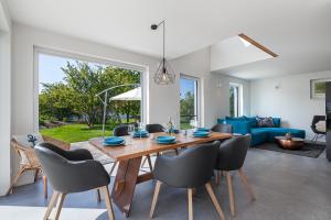 a dining room and living room with a table and chairs at Ferienhaus Rügen-Relax in Trent