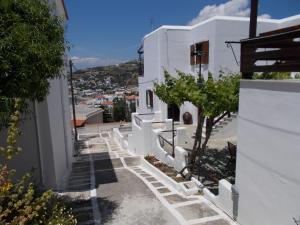 a white house with stairs leading down to the street at Sofirene Sea Scape in Batsi