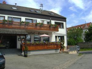 a building with a balcony with flowers on it at Gasthof ´s Gräbele in Tübingen
